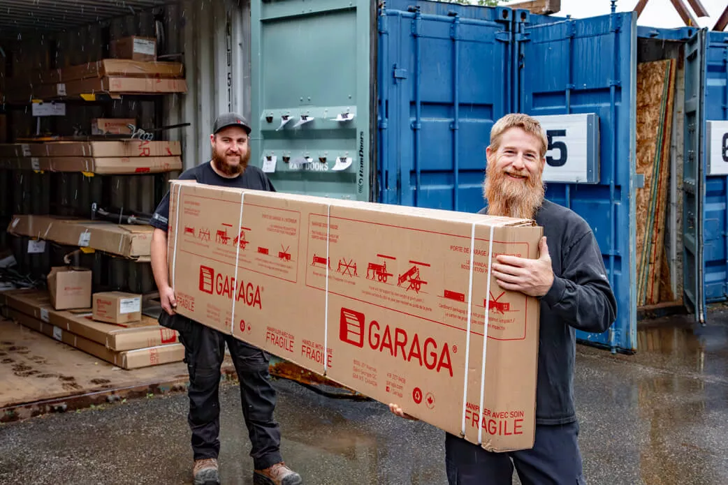 Two Portes Ram Doors employees with a Garaga garage door in preparation for a door installation in Ottawa