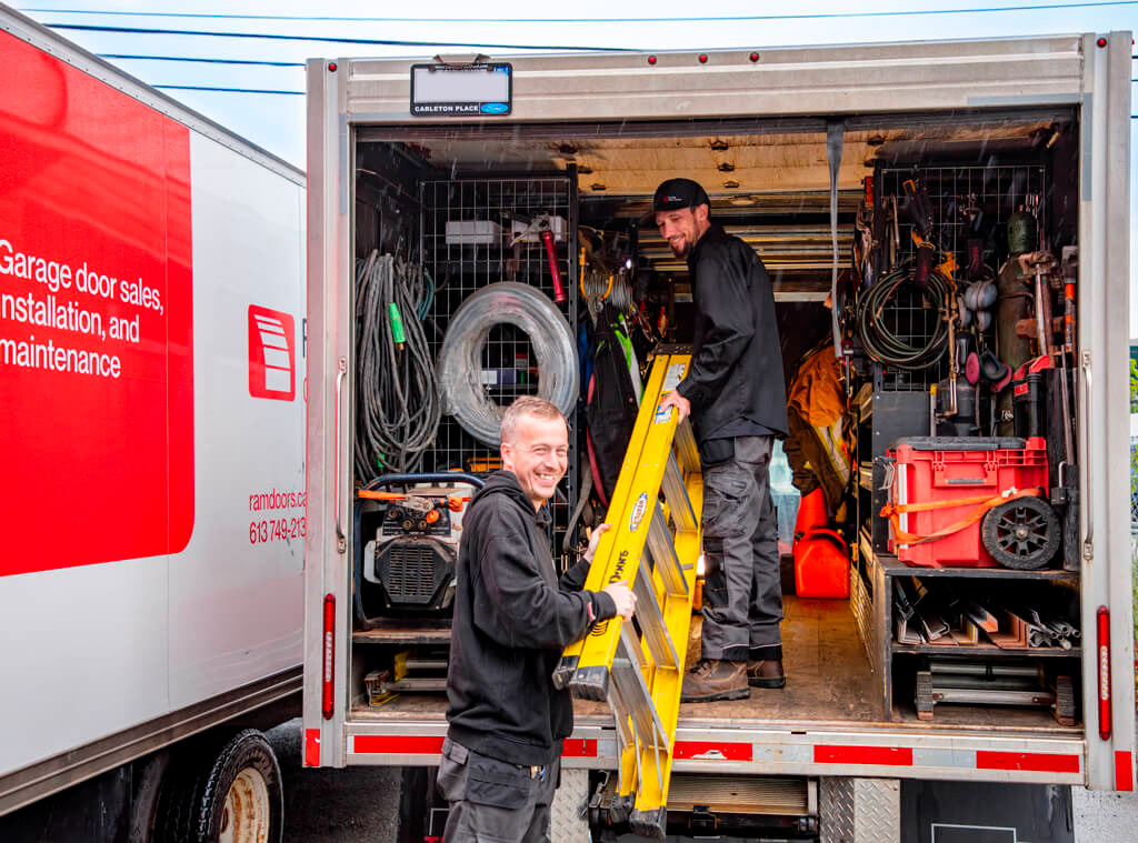 Two Portes Ram Doors technicians prepare the service truck for installation or repair for a residentials or a commercials garage door